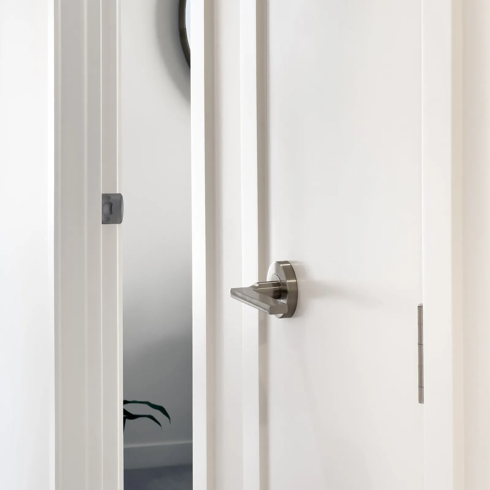 Satin nickel door lever fitted to a white interior door